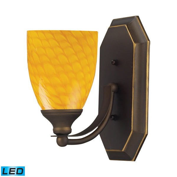 1 Light Vanity In Aged Bronze And Canary Glass - LED Offering Up To 800 Lumens (60 Watt Equivalent) With Full Range Dimming. Includes An Easily Replaceable LED Bulb (120V).