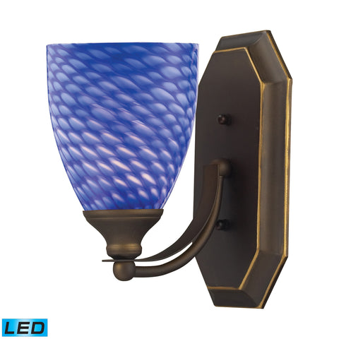 1 Light Vanity In Aged Bronze And Sapphire Glass - LED Offering Up To 800 Lumens (60 Watt Equivalent) With Full Range Dimming. Includes An Easily Replaceable LED Bulb (120V).